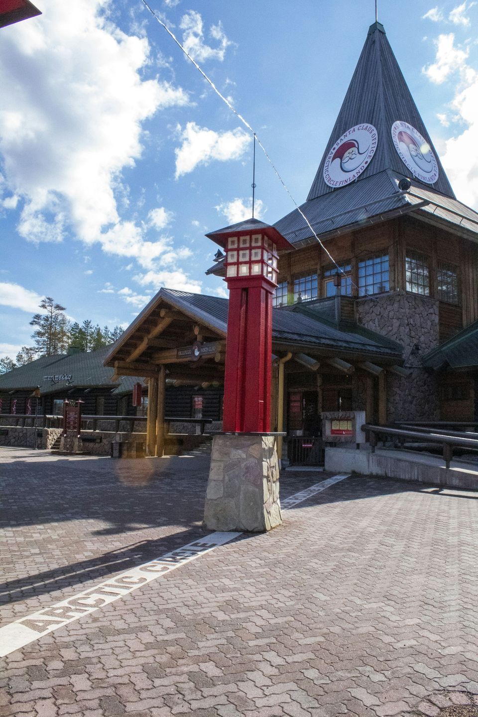 The main building of Santa Claus Village with its red post, on the Arctic Circle line in Rovaniemi